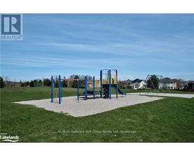 A playground with a slide and swings in a park.