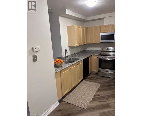 A kitchen with wooden cabinets and a stainless steel oven.