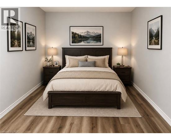 A bedroom with a large bed and two lamps.