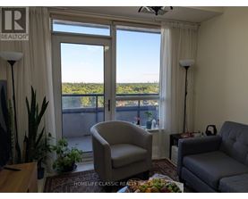 A living room with a view of the outdoors through the sliding glass doors.