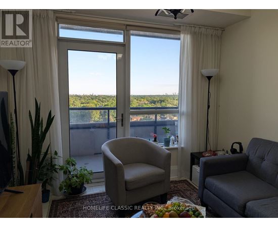 A living room with a view of the outdoors through the sliding glass doors.