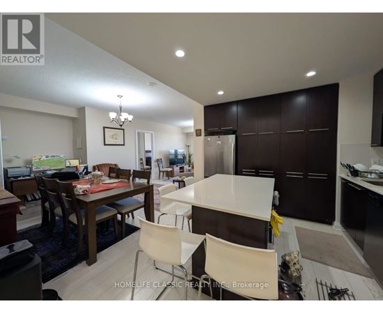A modern kitchen with a dining table and chairs.