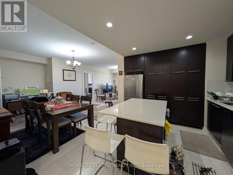 A modern kitchen with a dining table and chairs.
