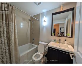 A bathroom with a toilet, sink, and shower.