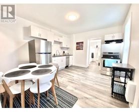 A modern kitchen with a dining table and chairs.