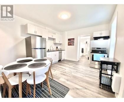 A modern kitchen with a dining table and chairs.