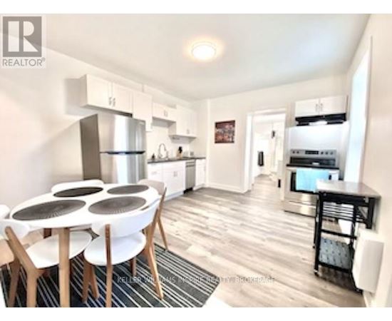 A modern kitchen with a dining table and chairs.