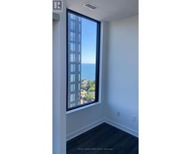 A room with a large window overlooking the ocean.