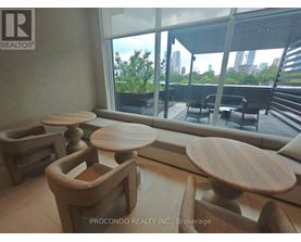 A room with wooden furniture and a view of the city.