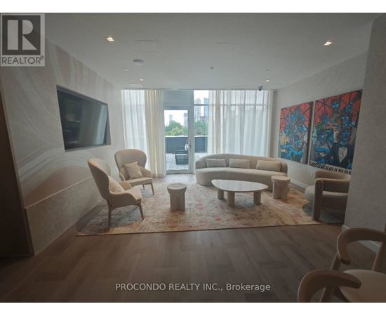 A living room with a flat screen TV and a large painting on the wall.