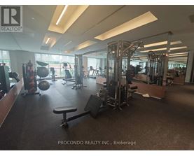 A gym with a variety of equipment including weights and cardio machines.