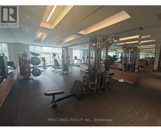 A gym with a variety of equipment including weights and cardio machines.