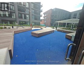 A blue pool in the middle of a wooden deck.