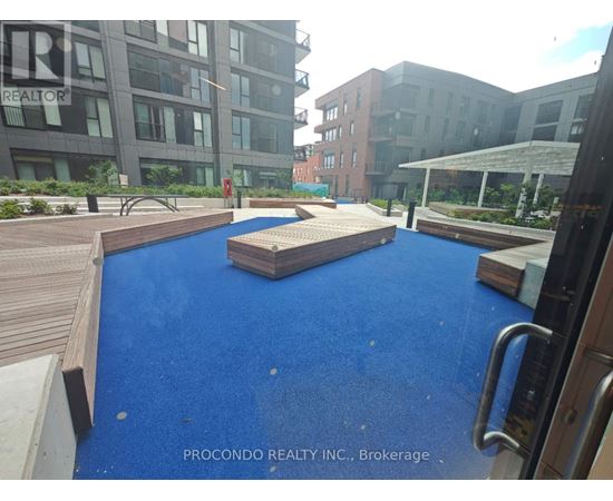 A blue pool in the middle of a wooden deck.