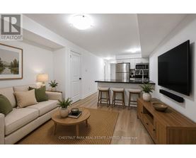 A living room with a couch, a coffee table, and a television.