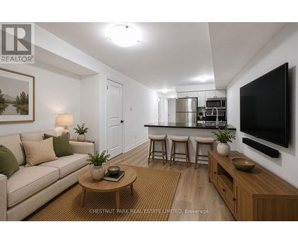 A living room with a couch, a coffee table, and a television.