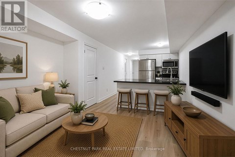 A living room with a couch, a coffee table, and a television.