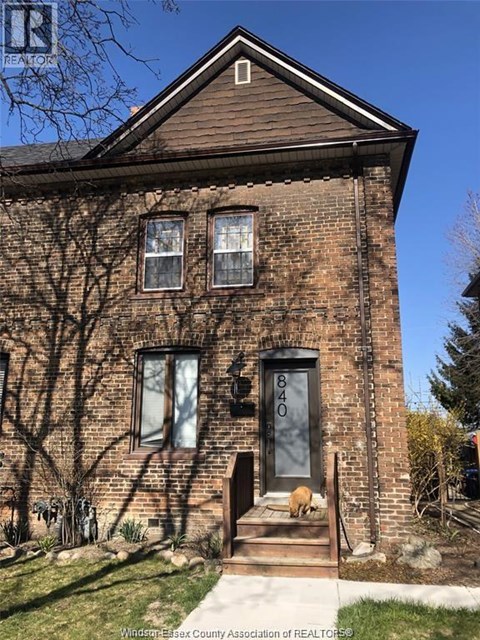 A brown house with the number 840 on the front door.