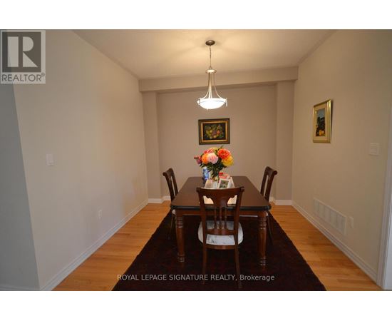 A dining room with a table set for two.