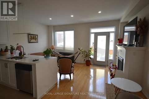 A kitchen with a dining table and chairs.