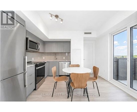 A modern kitchen with a table and chairs.