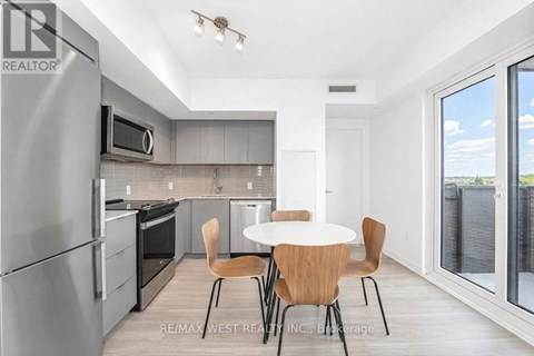 A modern kitchen with a table and chairs.