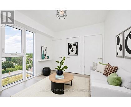 A living room with a couch, a coffee table, and pictures on the wall.