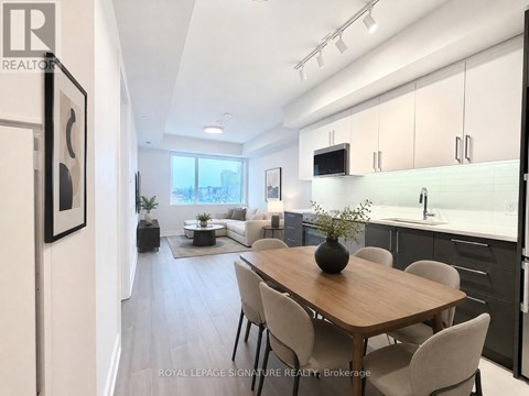 A modern kitchen with a dining table and chairs.