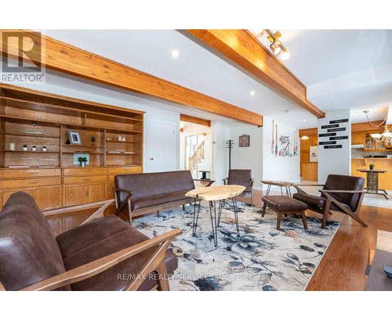 A living room with brown leather couches and a wooden floor.