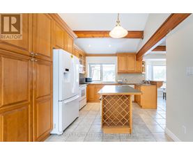 A kitchen with wooden cabinets and a white refrigerator.