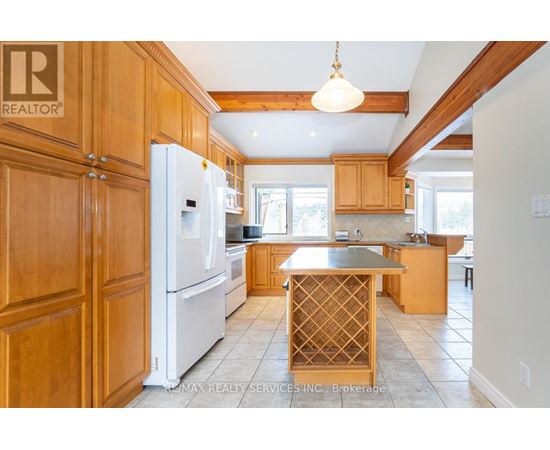 A kitchen with wooden cabinets and a white refrigerator.