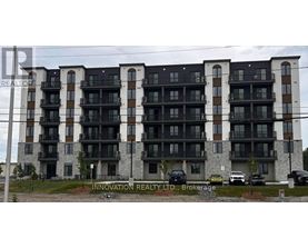 A multi-story building with balconies and a sign that reads "Innovation Realty LTD, Brokerage".