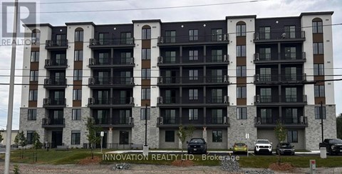 A multi-story building with balconies and a sign that reads "Innovation Realty LTD, Brokerage".
