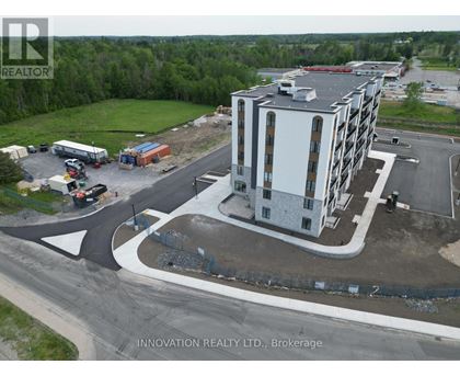 A building under construction with a sign that says Innovation Realty Ltd., Brokerage.