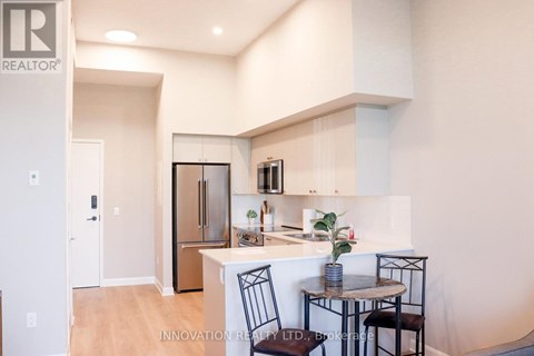 A modern kitchen with a dining table set up.
