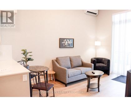 A living room with a couch, chair, and coffee table.