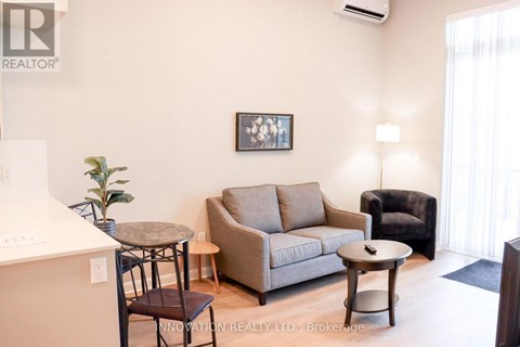 A living room with a couch, chair, and coffee table.