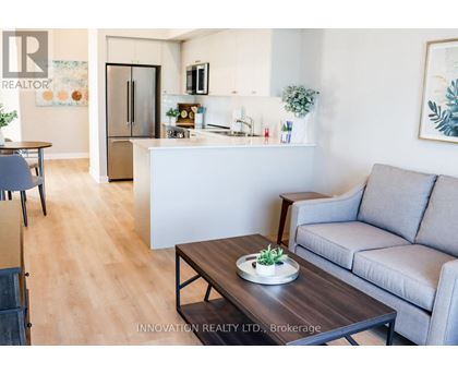 A modern living room with a grey couch and a wooden coffee table.