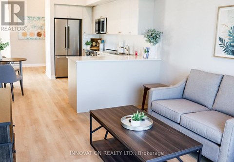 A modern living room with a grey couch and a wooden coffee table.