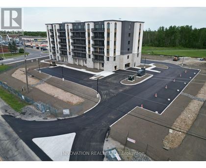 A large building with a parking lot in front of it.