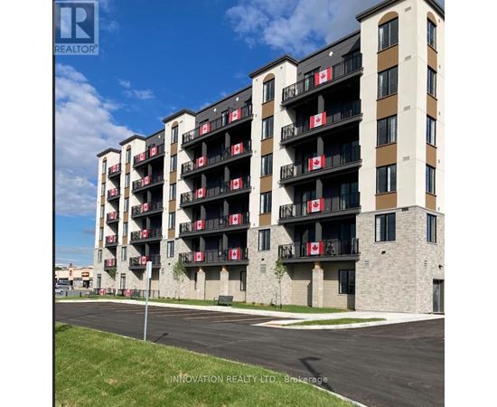 A building with balconies has Canadian flags on them.