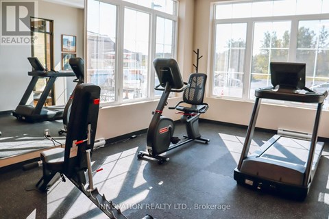 A gym with treadmills, exercise bikes, and elliptical machines.