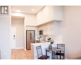 A modern kitchen with a dining table set up.