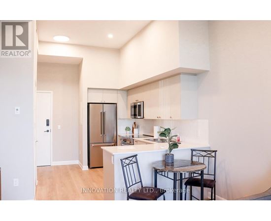 A modern kitchen with a dining table set up.