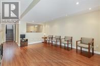 A living room with a row of chairs and a logo that says REALTOR.
