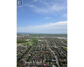 A bird's eye view of a residential area with houses and greenery.