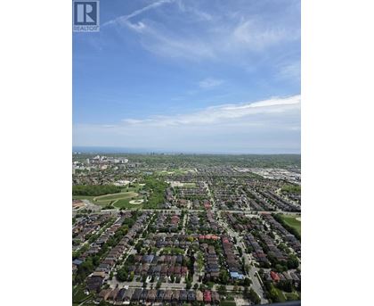 A bird's eye view of a residential area with houses and greenery.