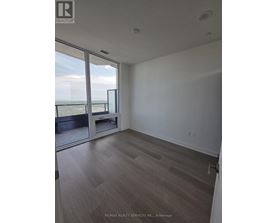 A room with a view of the ocean through a sliding glass door.