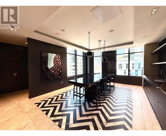 A black and white chevron rug is on the floor of this modern living room.