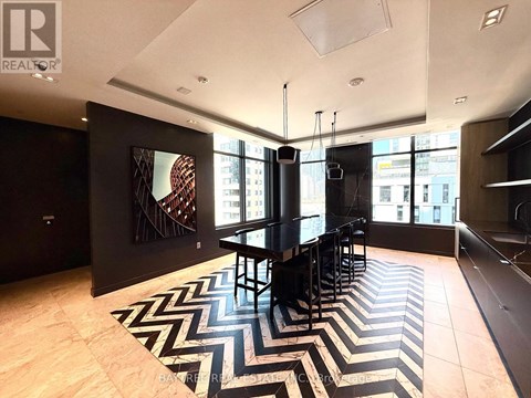A black and white chevron rug is on the floor of this modern living room.